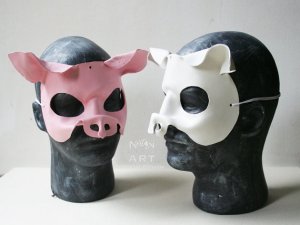 Photo Showing a white and a pink pig mask